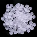 Close-up of white four-petal fabric flower DIY patches for hairpins and clothing crafting. - 60-piece Set / White