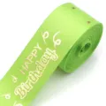 Close-up of lime green polyester ribbon with gold foil Happy Birthday text for gift wrapping. - Fruit Green