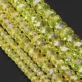 Detailed macro shot of faceted yellow crystal rondelle spacer beads, glittering crystal clear. - Lemon Yellow AB