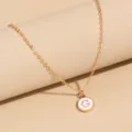 Gold-tone chain necklace featuring a round white enamel initial letter G pendant accessory. - Letter G