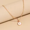 Gold-toned letter K pendant necklace with white enamel circular design for women daily wear. - Letter K