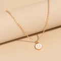 Gold-tone chain necklace featuring a chic white enamel round pendant with letter Q pendant. - Letter Q