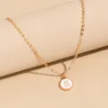Minimalist gold metal chain necklace featuring a stylish white enamel round pendant with letter S. - Letter S