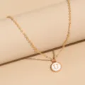Simple gold-tone chain necklace featuring a round white enamel letter U pendant item. - Letter U