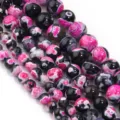 Dettaglio ravvicinato di perline in agata di fuoco bicolore, perfette per gioielli fai da te. - Diametro 6mm / Fiamma Rosso Rosa