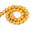 Close-up detail of yellow synthetic stone loose beads with elegant gold line patterns for DIY. - 6mm / Yellow Gold Line Turquoise