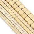 Close-up detail of square gold-plated hematite beads, perfect for DIY jewelry making accessories. - Cube Bead / 4mm (Approx 92pcs) / Light gold