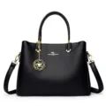 Black leather tote bag for women, stylish shoulder handbag with top handles and floral charm. - Black