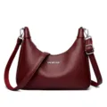 Burgundy leather shoulder bag for women, stylish casual crossbody bag with wide strap and hardware. - Fuschia
