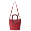 Red leather bucket bag detail showing contrast handle and adjustable strap design. - Upgrade Version / Red