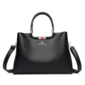 Elegant black leather women handbag with top handle and shoulder strap for daily commuting. - Black