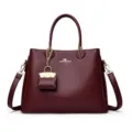 Burgundy soft leather tote handbag with top handles, shoulder strap and cute mini charm. - Ankara Red