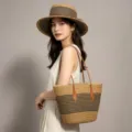 Detailed view of the stylish woven straw hat and tote bag set with chic stripe patterns. - Bag And Hat Set / Khaki Black Striped