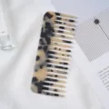 Detailed view of the acetate hair comb featuring a stylish marble pattern and wide teeth. - 4# 11.8x4.6cm Beige Acetate Hair Comb