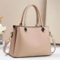 Detailed view of stylish khaki top handle shoulder bag with chic hardware and premium leather. - Apricot