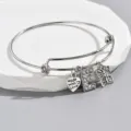 Adjustable silver wire bangle bracelet with heart rhinestone letter E and butterfly charms. - Style E