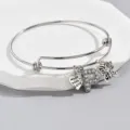 Silver adjustable letter P bangle bracelet detail featuring cute heart and butterfly charms. - Pattern P