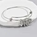 Adjustable silver wire bangle with rhinestone letter R, heart and butterfly charms. - Pattern R