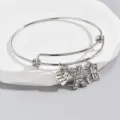 Adjustable silver-tone charm bracelet featuring a rhinestone letter X, heart, and butterfly. - X Style