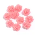 Detailed shot of pink resin rose flower cabochons for DIY phone case and jewelry making. - Deep Pink
