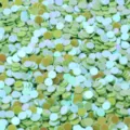 Close-up detail of 3.0mm iridescent round PVC sequins for nail art and clothing accessories. - 30g/Pack / Iridescent Green