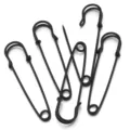 Detail view of black metal safety pins, ideal for DIY crafts, clothing adjustment and brooch bases. - Black