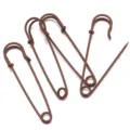 Brown metal safety pins detail view, ideal for DIY crafts, sweater brooch pins and waist adjustment. - Coffee
