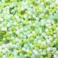 Close-up detail of mixed green and white glass seed beads, perfect for DIY jewelry and crafts. - 40g/Pack / Mixed Apple Green Series