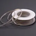 Detailed view of white and gold edge polyester ribbon roll for gift wrapping and DIY bows. - 3mm 18m/Roll / Gold Edge White