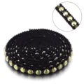 Black woven ribbon trim with shiny gold beads, elegant DIY clothing accessory spool. - Beaded Lace in Black and Gold