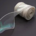 Detail shot of iridescent sheer ribbon roll, perfect for gift wrapping and party decor. - Milk Yellow