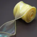 Detailed view of a shimmering yellow organza ribbon roll for gift wrapping and party decor. - Diameter 6cm 10 Yards/Pack 29g / Lemon Yellow