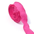 Closeup detail of bright pink ruffled crinkle ribbon roll, soft fabric trim texture. - Rose Red