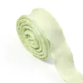 Close-up of a light green bubble wrinkle ribbon, showing delicate texture and fine details. - Light Green