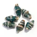 Detail view of blue-green ceramic conch beads with white dots, ideal for handmade jewelry parts. - Length 20mm Width 11mm Hole 2mm / Dark Green