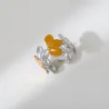 Detailed close-up of the two-tone stainless steel multi-flower open ring surface texture. - Four-leaf Clover Patchwork