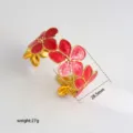Detailed view of gold-tone red enamel heart flower open cuff bracelet, elegant jewelry piece. - 38