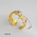 Gold open cuff bracelet with enameled seashell and starfish design, elegant fashion jewelry. - 39