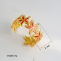 Gold starfish cuff detail view, red enamel inlay, open bracelet closeup showing 27mm size. - 40