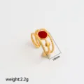 Detailed shot of stainless steel adjustable ring with red enamel and twisted gold bands. - Style 269