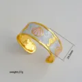 Detail shot of gold-plated open cuff bracelet with white pink enamel shell seahorse design. - 44