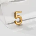 Gold number 5 metal pendant charm close-up detail shot, minimalist jewelry accessory. - 5