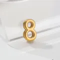 Gold number 8 charm pendant detail close up view, shiny polished metal jewelry accessory. - 8