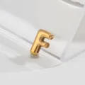 Gold stainless steel letter F pendant charm close-up, stylish niche jewelry accessory detail view. - Letter F
