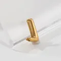 Detailed view of a shiny gold letter charm pendant, perfect jewelry accessory craftsmanship. - Letter J
