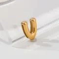 Close-up detail of a shiny gold letter V pendant, elegant metallic gloss and smooth finish. - Letter V