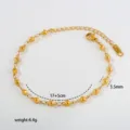 Detail view of gold stainless steel bead chain bracelet showing size and weight specs. - 10-16