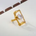 Stainless steel ring detail showing the shimmering white cubic zirconia and irregular gold frame. - Oval Stone Geometric Style / Gold