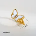 Stainless steel butterfly ring with white mother-of-pearl and zircon detail close-up. - 553