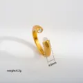 Minimalist gold stainless steel open ring with sparkling zircon and white bead detail. - 554
